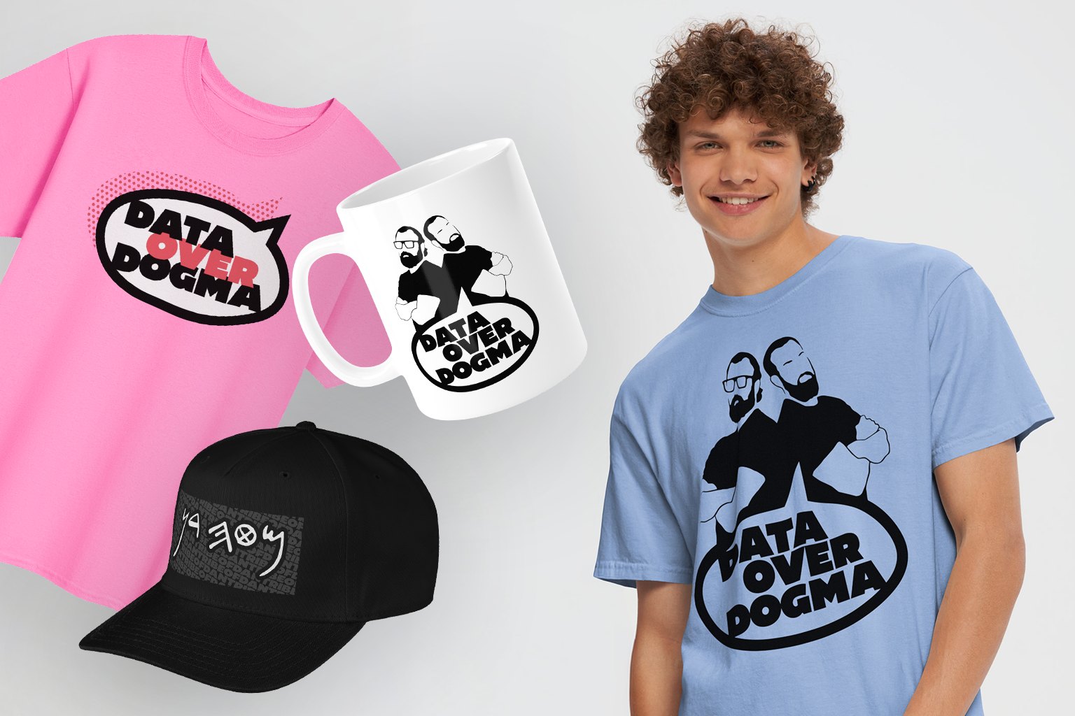 Data Over Dogma merch: a pink logo tee, a mug and a light blue tee with the Dans' silhouettes, and a black cap